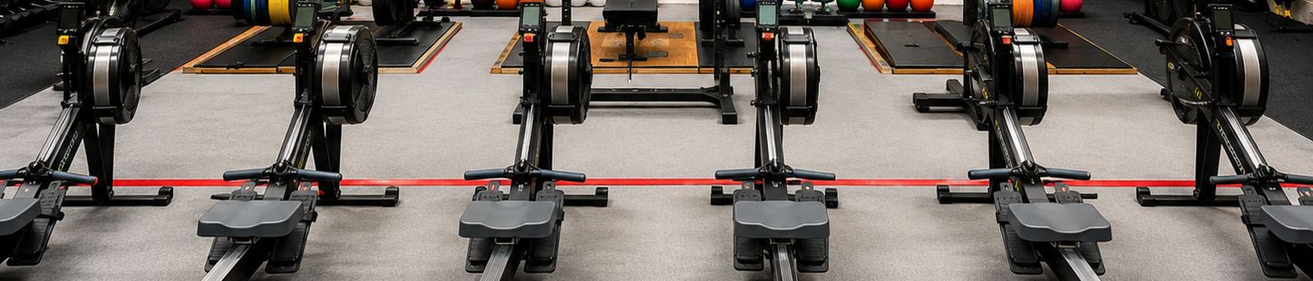 Rowing machines lined up across the training floor