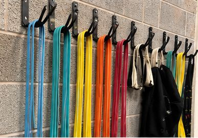 Resistance bands and straps hanging on wall hooks